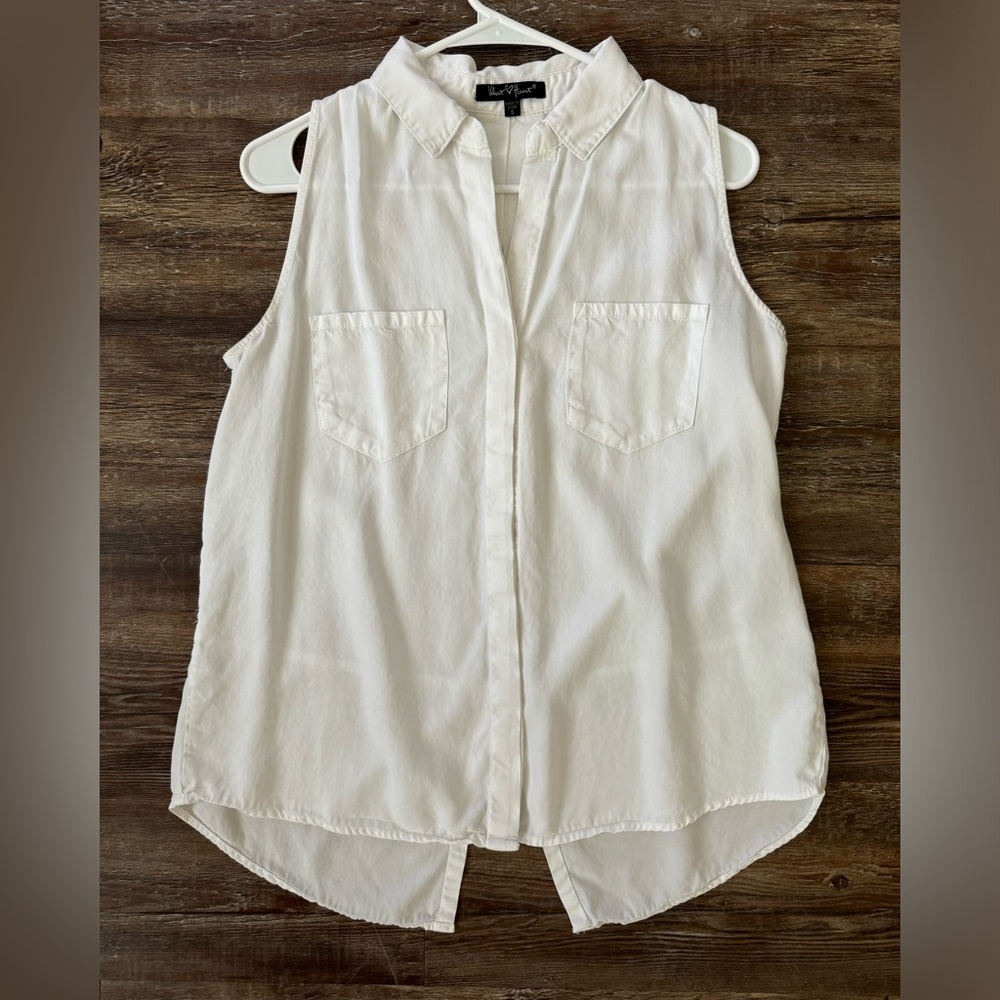 White sleeveless button down.